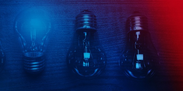Four light bulbs in a row. One bulb points up and lights up (idea).
